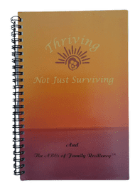 A spiral bound book with the title of thriving not just surviving and an image of sun.