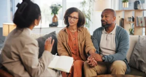 Couple holding hands during counseling session