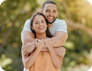 Happy couple embracing outdoors.